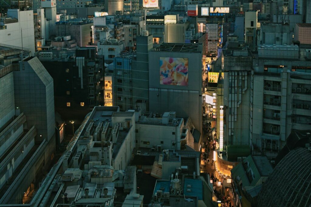 Alt: Aerial view of a bustling city street at dusk.
