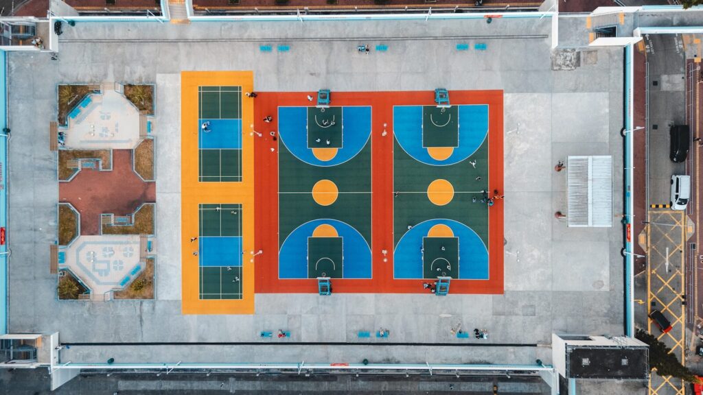 Aerial view of colorful basketball courts and tennis courts.