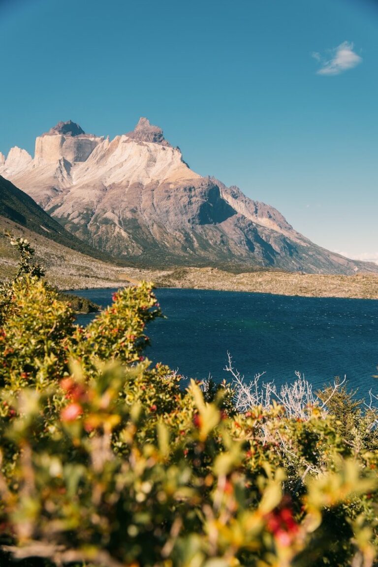Jagged mountains rise above a dark blue lake.